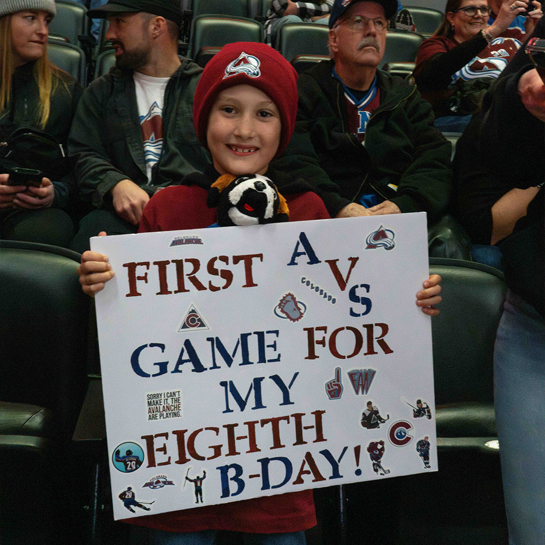 Bernie high fives a kid at the rink