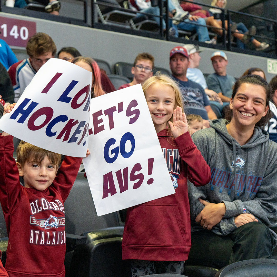 Family at a watch party cheering for the Avs